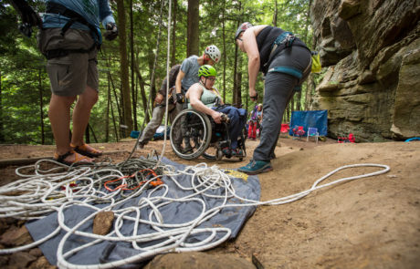Volunteers Helping Woman in Wheelchair at Crag