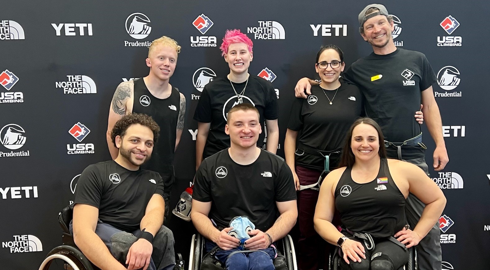 The Paradox Sports Competitive Climbing Team poses for a group shot. Everyone is wearing black The North Face tank tops and t-shirts with a Paradox Sports logo on the front.